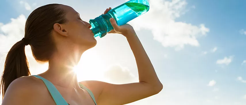girl drinking water after exercise